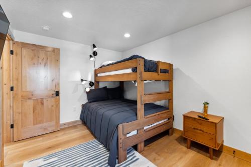 a bedroom with a bunk bed and a wooden cabinet at New! Brand new Downtown Loft 205 - Lake views, half block from lake, restaurants, and shopping in McCall