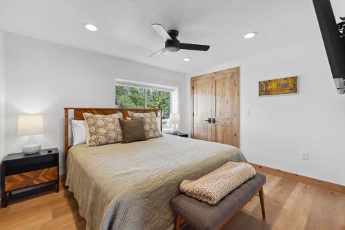 a bedroom with a bed and a ceiling fan at New! Brand new Downtown Loft 205 - Lake views, half block from lake, restaurants, and shopping in McCall