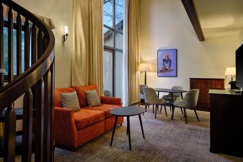 a living room with a couch and a table at Delta Hotels by Marriott St Pierre Country Club in Chepstow