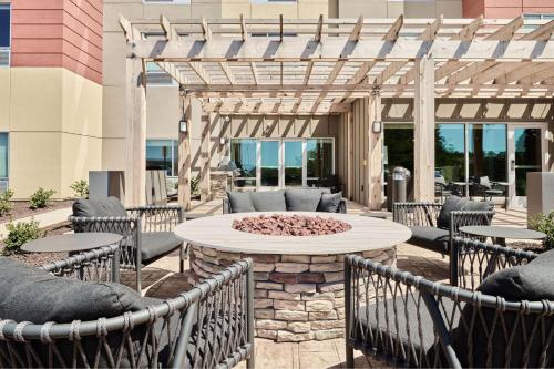 a patio with a table and chairs and a fire pit at TownePlace Suites by Marriott Chattanooga South, East Ridge in Chattanooga
