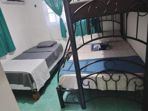 a bedroom with two bunk beds in a room at Cozy House with Pool and AC Casa Armando in Cozumel