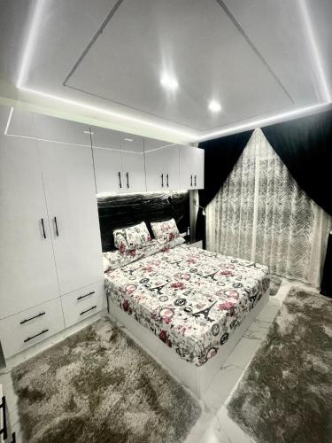 a bedroom with a bed and white cabinets at Porto matrouh Magic sea in Marsa Matruh