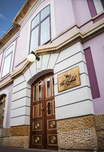 a building with a sign above a door at The Orchids in Bogotá