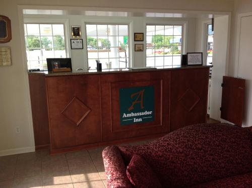 a large wooden reception desk in a room with at Ambassador Inn in Fayetteville