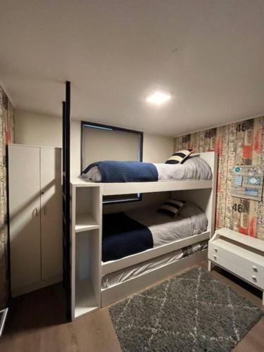 a bedroom with two bunk beds with a mirror at Departamento Costa Pucón in Pucón