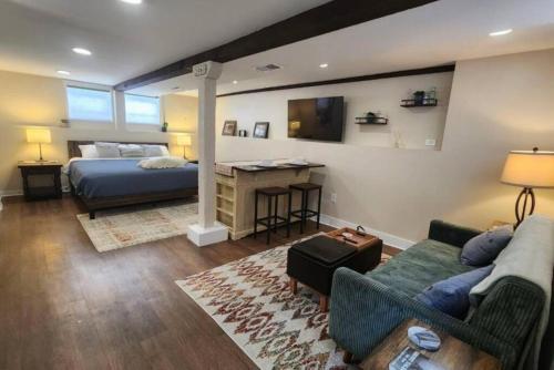 a living room with a bed and a couch at Grand Hideaway - King Bed! in Astoria, Oregon