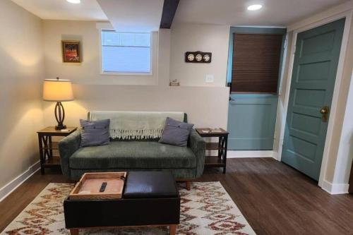 a living room with a couch and a door at Grand Hideaway - King Bed! in Astoria, Oregon
