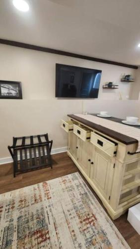 a bathroom with a sink and a tv on the wall at Grand Hideaway - King Bed! in Astoria, Oregon