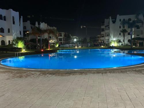 a large blue swimming pool at night at Luxury Apartment in Cabo in Cabo Negro