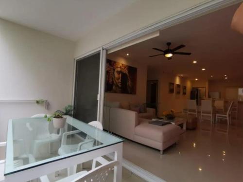 a living room with a couch and a ceiling fan at Marina Excelsior in Playa del Carmen
