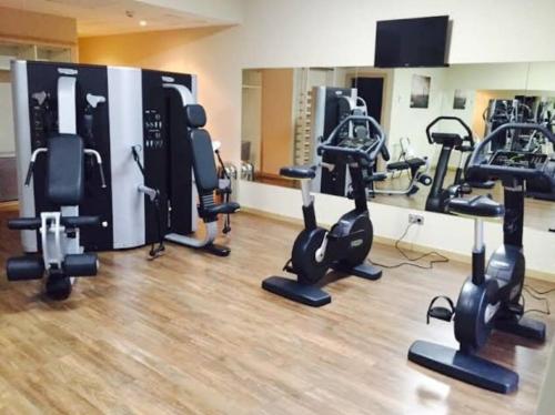 a gym with a bunch of exercise bikes in a room at Marina Excelsior in Playa del Carmen