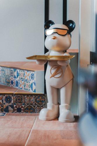 a toy person holding a plate of food at Annong Image Vacation Home in Sanxing