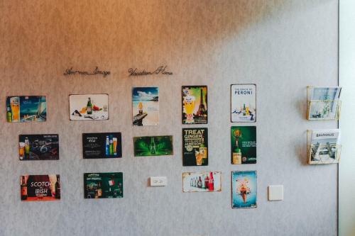 a wall with a bunch of pictures on it at Annong Image Vacation Home in Sanxing