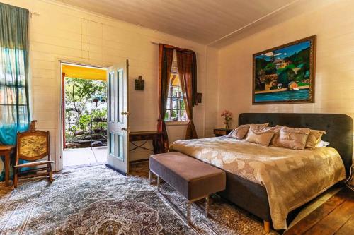 a bedroom with a bed and a table and a door at Robbie Burns Hotel Wyndham in Burragate