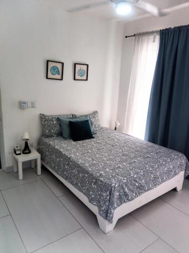a bedroom with a bed and a window at Ocean Bliss in Sosúa