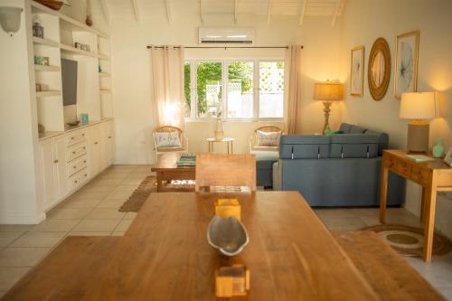 a living room with a couch and a table at The Heart Villa, Exquisite Pool to Relax & Unwind in Golden Grove