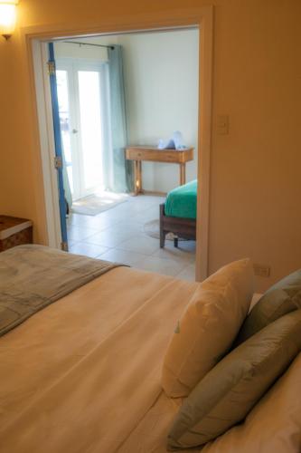 a bedroom with a bed and a door to a room at The Heart Villa, Exquisite Pool to Relax & Unwind in Golden Grove
