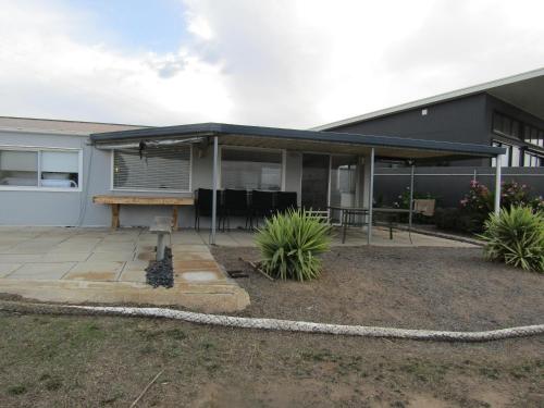 a house with a patio with a picnic table at 21 - Black Point in Pine Point