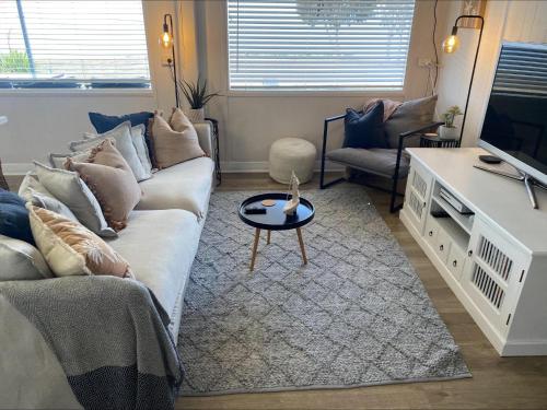 a living room with a couch and a tv at 21 - Black Point in Pine Point