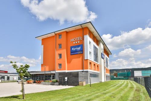 an orange building with a hotel sign on it at Kyriad Pontarlier in Pontarlier