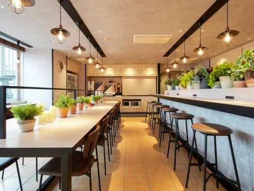 a large kitchen with a long table and chairs at Super Hotel Okazaki in Okazaki