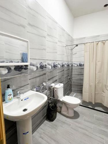 a bathroom with a sink and a toilet at Spacious apartment for a comfortable stay in Al Hoceïma
