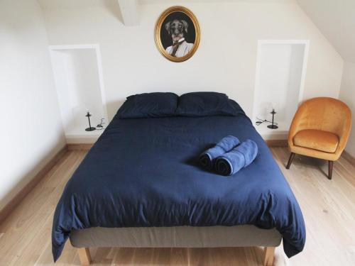 a bedroom with a bed with two blue pillows at Gîte de charme avec spa, piscine intérieure et jardin clos près de Chinon - FR-1-381-553 in Beaumont-en-Véron