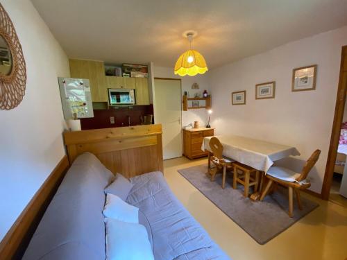 une chambre avec un lit, une table et des chaises dans l'établissement Appartement cosy à Châtel - 4 pers, balcon, parking, proche télécabine, accès WIFI, animaux admis - FR-1-198-265, à Châtel