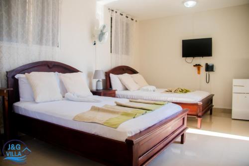 Postel nebo postele na pokoji v ubytování J&G Villa Hotel