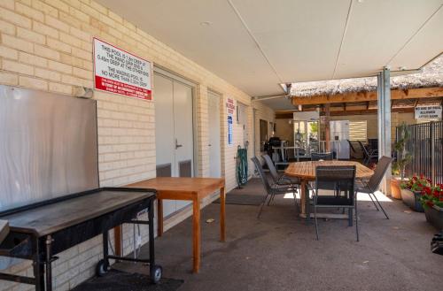 a room with tables and chairs in a building at Bunbury Motel and Apartments in Bunbury