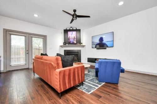 a living room with a couch and a fireplace at ProlificSuites Escape - Stylish Spaces & Prime Location in Houston
