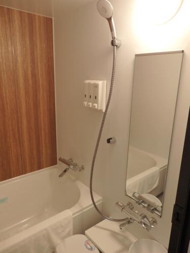 a bathroom with a shower and a toilet and a sink at Sapporo Washington Hotel Plaza in Sapporo