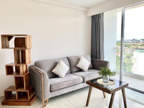 a living room with a couch and a table at Deco Home @ Aru Suites in Kota Kinabalu