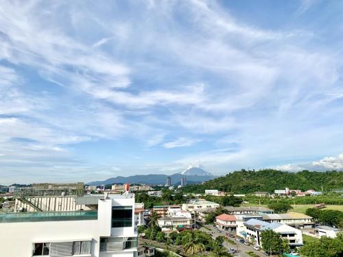 a view of a city with a cloudy sky at Deco Home @ Aru Suites in Kota Kinabalu