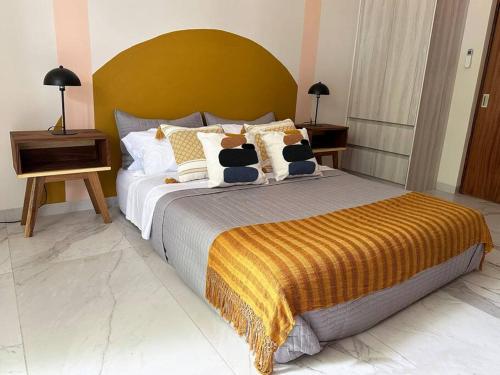 a bedroom with a large bed with two stuffed animals on it at Biulu Apartment at Tangolunda Bay in Tangolunda