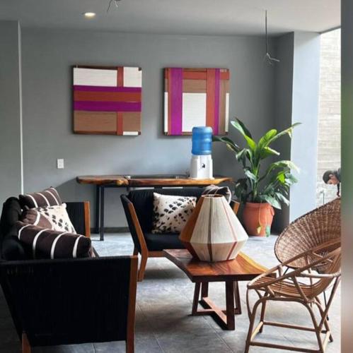 a living room with a couch and chairs and a table at Biulu Apartment at Tangolunda Bay in Tangolunda