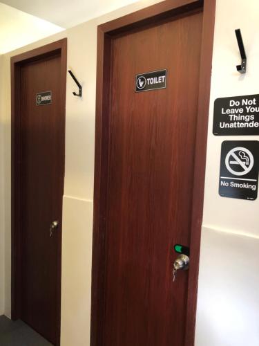 a pair of doors in a room with a sign on it at Cafe Moto Hostel in Puerto Princesa City