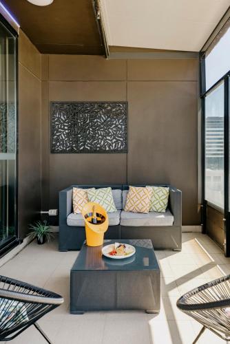 a living room with a couch and a table at The Constance Fortitude Valley in Brisbane