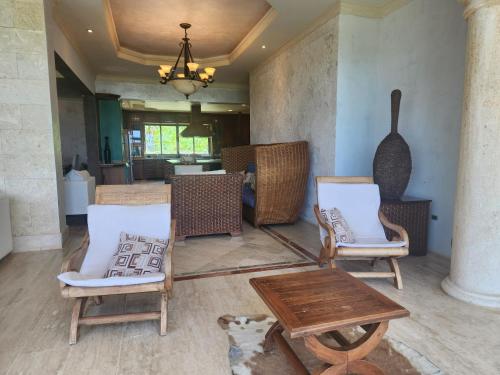 a room with two chairs and a table and a table at Villa Tesoros del Mar - Luxury Beachfront Villa with Natural Pool, Jacuzzi, Mountain Views, Yoga, BBQ, Wi-Fi, Pet & Family Friendly, Barahona Adventures in El Arroyo