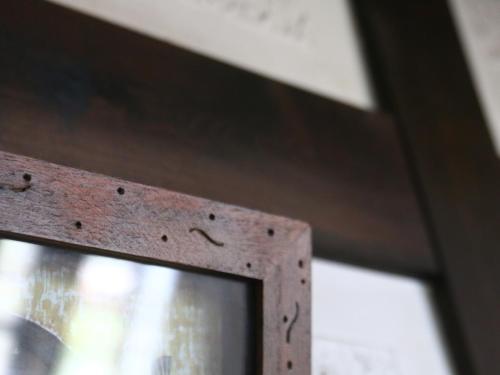a close up of a metal door with a window at Pension Mon Repos in Nozawa Onsen