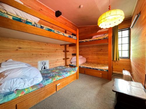 a bedroom with two bunk beds in a cabin at Pension Mon Repos in Nozawa Onsen