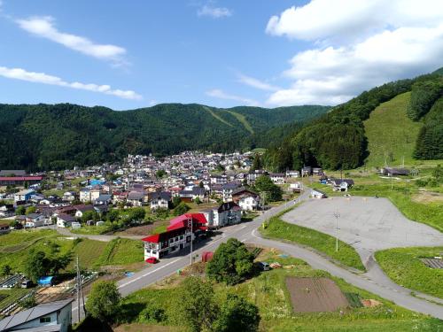 an aerial view of a small town in the mountains at Pension Mon Repos in Nozawa Onsen
