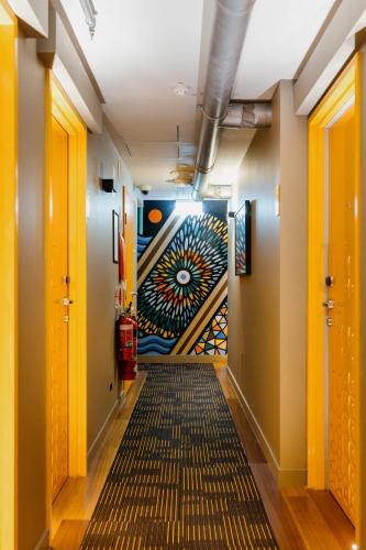 a hallway with a painting on the wall at The Constance Fortitude Valley in Brisbane