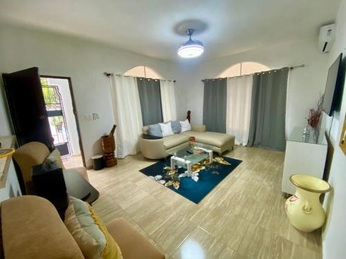 a living room with a couch and a table at Casa Tipo Villa, Piscina, Playas De RSJ a 4 min in Río San Juan