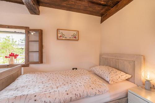 a bedroom with a bed and a window at Kolpa Holidays in Gradac
