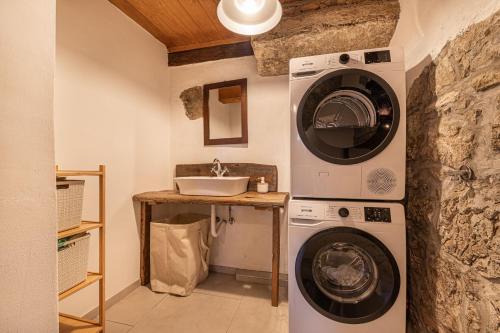 a bathroom with a washing machine and a sink at Kolpa Holidays in Gradac