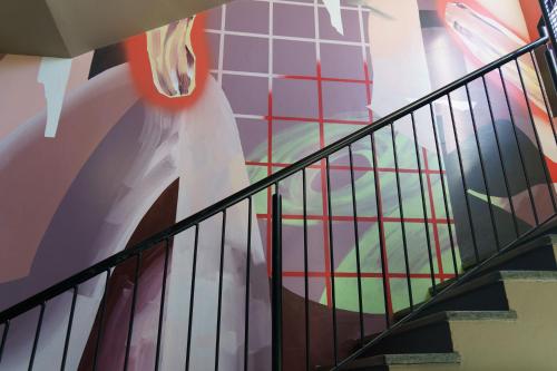 a spiral staircase with a painting on the wall at The Constance Fortitude Valley in Brisbane