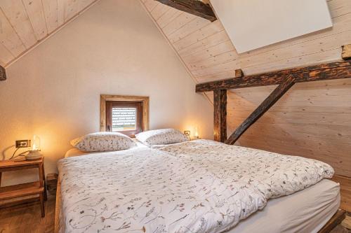 a bedroom with a large bed in a attic at Kolpa Holidays in Gradac
