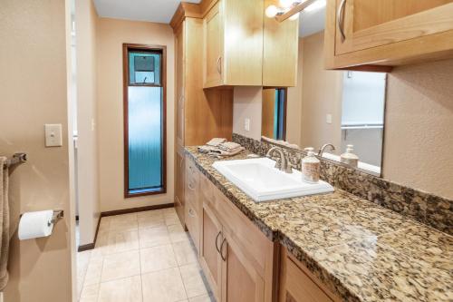 a bathroom with a sink and a counter top at PNW MCM 155ft Private Waterfront Gem on Raft Island with Hot Tub in Gig Harbor