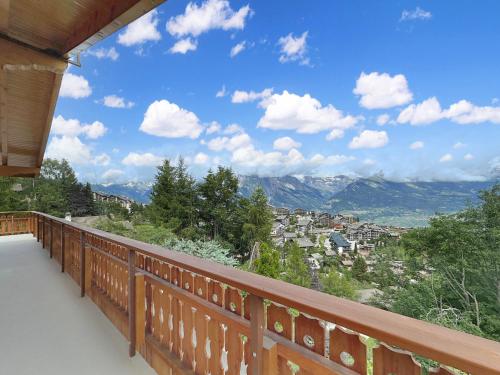 a balcony with a view of a city at Chalet Jaliver - 4 Valleys - Swiss Alps in Nendaz